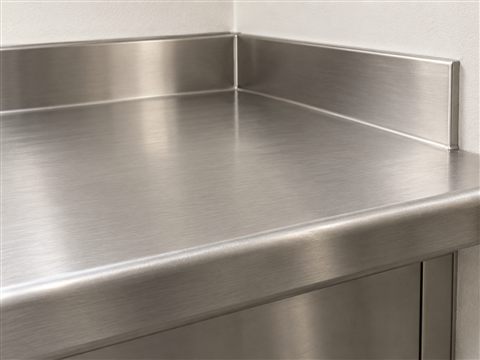 Illustration of a brushed metal worktop with a rounded front edge.